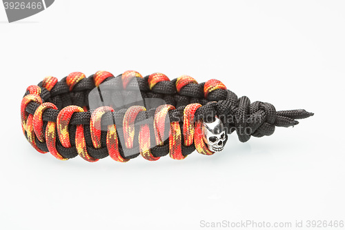 Image of black and orange braided bracelet on white background