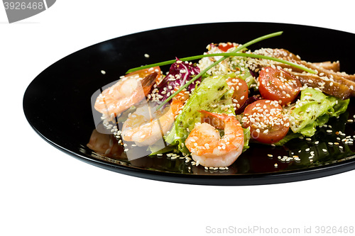 Image of perfect dish with shrimps on a black plate. seafood. Isolated  white background