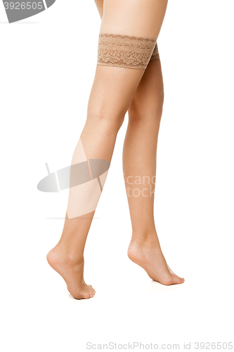 Image of Close-up of woman\'s legs in beige hoses