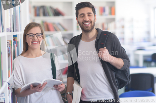 Image of students couple  in school  library