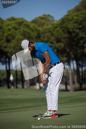 Image of golf player hitting shot at sunny day