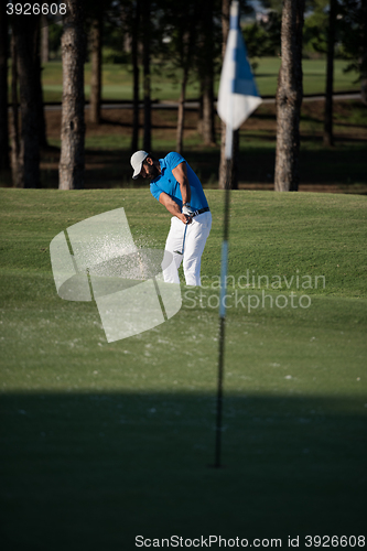 Image of pro golfer hitting a sand bunker shot