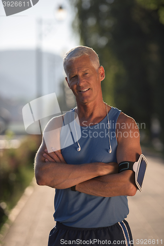 Image of portrait of handsome senior jogging man