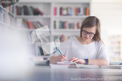 Image of female student study in school library
