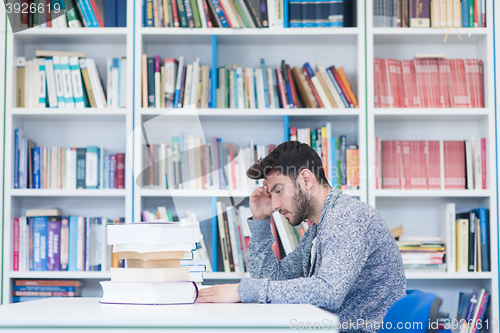 Image of portrait of student while reading book  in school library