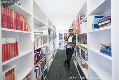 Image of student with tablet in library