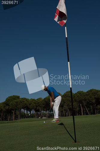 Image of golf player hitting shot at sunny day