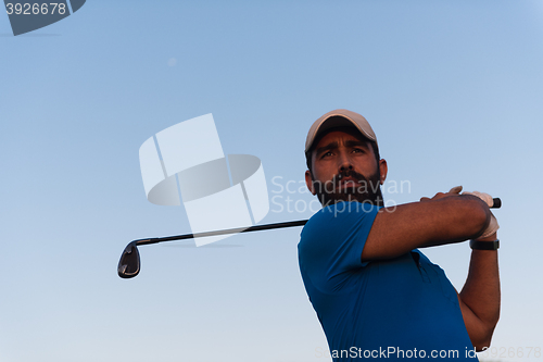 Image of golfer  portrait at golf course on sunset