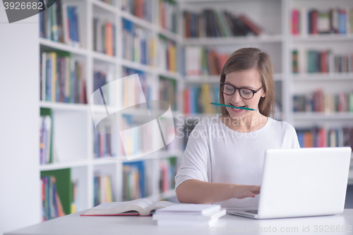 Image of female student study in school library