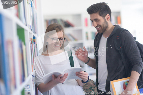 Image of students couple  in school  library