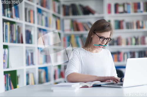 Image of female student study in school library