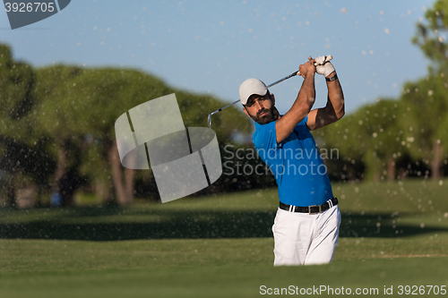 Image of pro golfer hitting a sand bunker shot