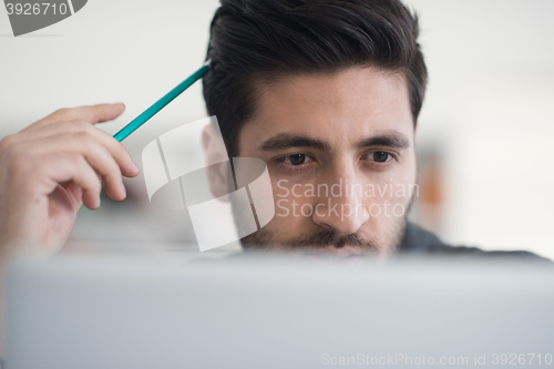 Image of student in school library using laptop for research