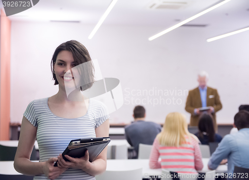 Image of portrait of happy female student in classroom