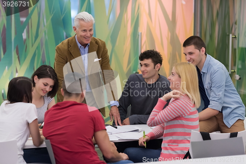 Image of teacher with a group of students in classroom