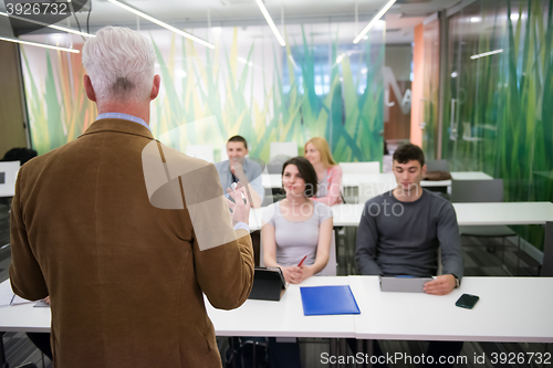 Image of teacher with a group of students in classroom