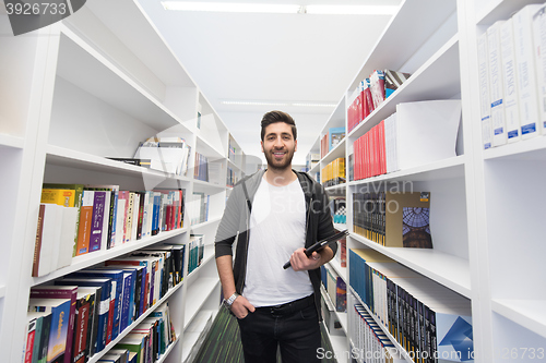 Image of student with tablet in library