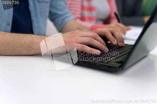 Image of close up of student hands typing on laptop