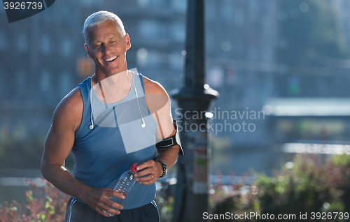 Image of portrait of handsome senior jogging man