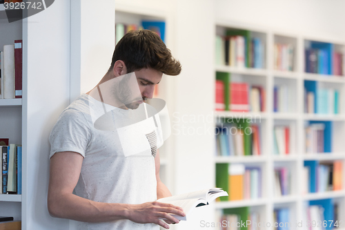 Image of student in school library using tablet for research