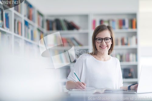 Image of female student study in school library