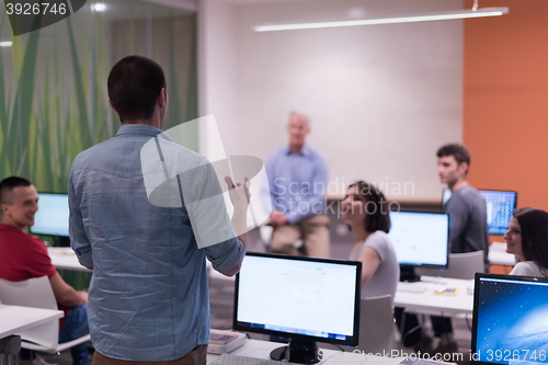 Image of student answering a question in classroom