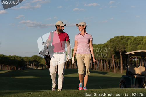 Image of couple walking on golf course