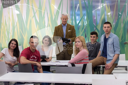 Image of portrait of  teacher with students group in background