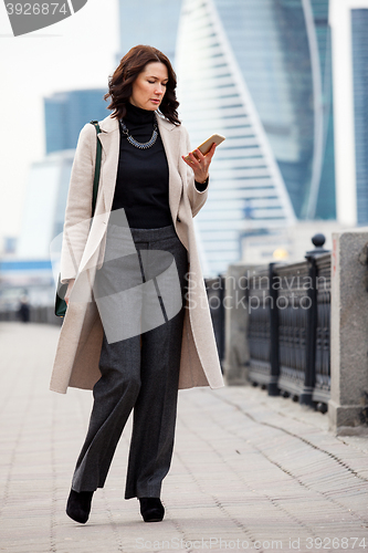 Image of woman messaging with smartphone