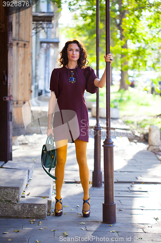 Image of woman in a fashion burgundy dress