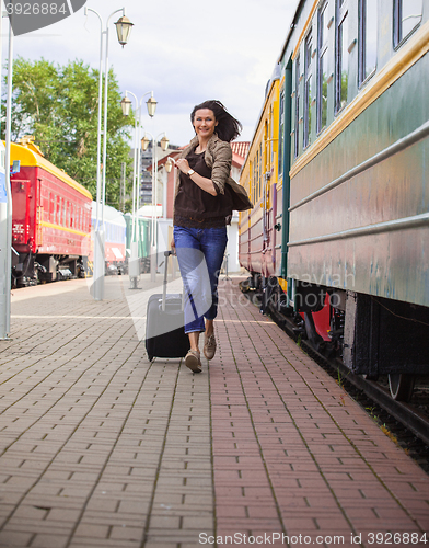 Image of woman with luggage on the station platform