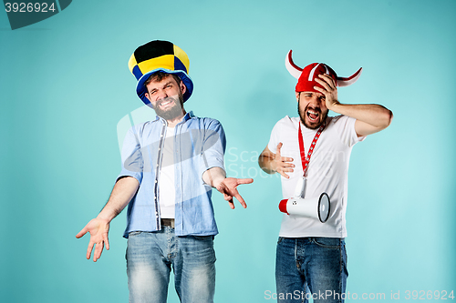 Image of The two football fans with mouthpiece over blue