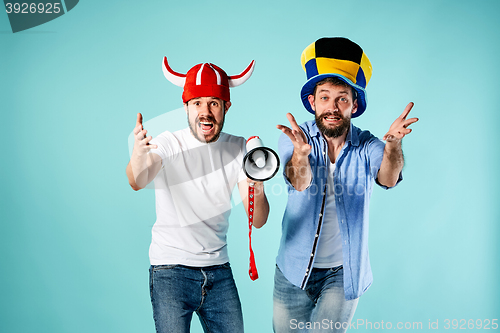 Image of The two football fans with mouthpiece over blue