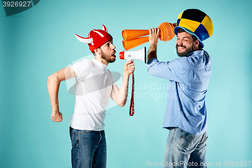 Image of The two football fans with mouthpiece over blue