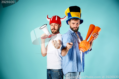 Image of The two football fans with mouthpiece over blue