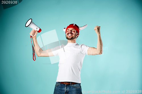 Image of The football fan with mouthpiece over blue