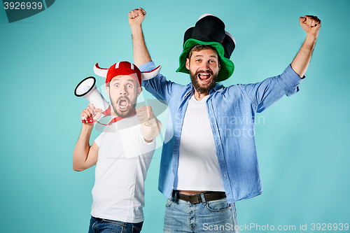 Image of The two football fans with mouthpiece over blue