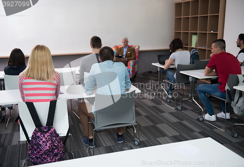 Image of teacher with a group of students in classroom