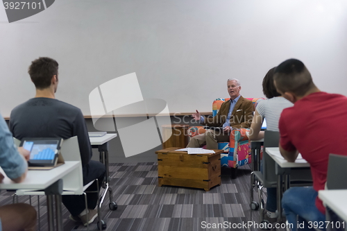 Image of teacher with a group of students in classroom