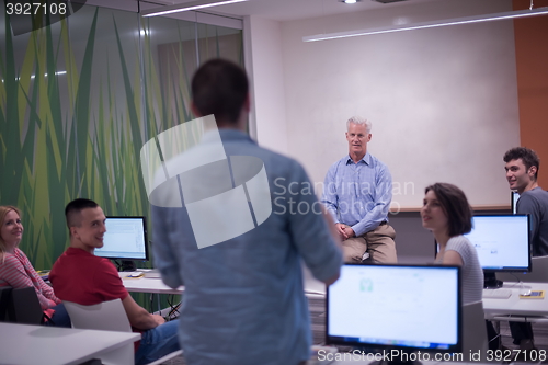 Image of student answering a question in classroom