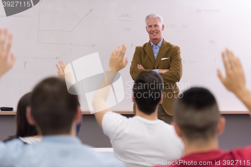 Image of teacher with a group of students in classroom