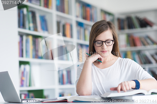 Image of female student study in school library