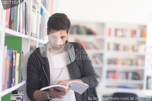 Image of portrait of student while reading book  in school library