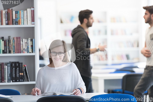 Image of female student study in school library, group of students in bac