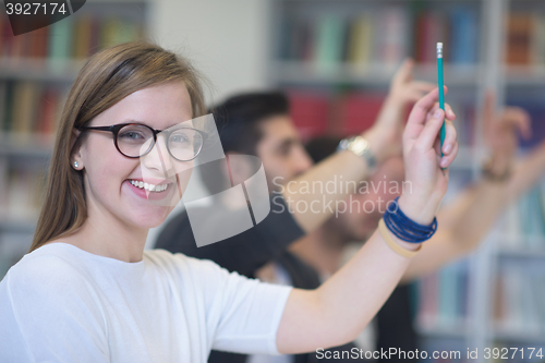 Image of group of students  raise hands up