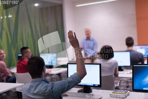 Image of student answering a question in classroom