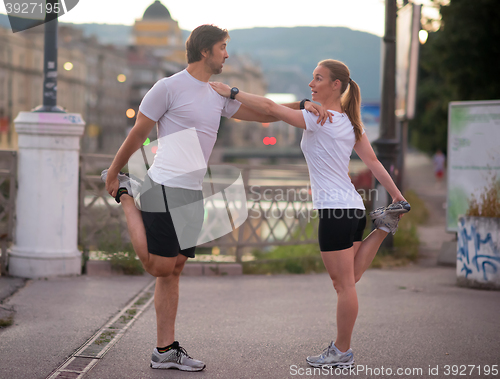 Image of couple warming up before jogging