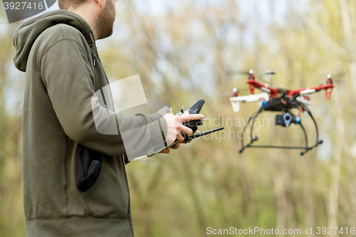 Image of Man controling a drone.