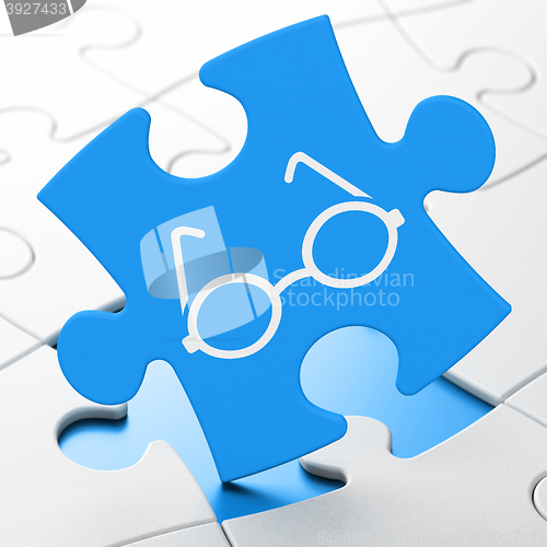 Image of Science concept: Glasses on puzzle background