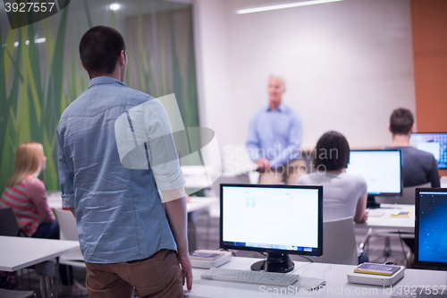 Image of student answering a question in classroom